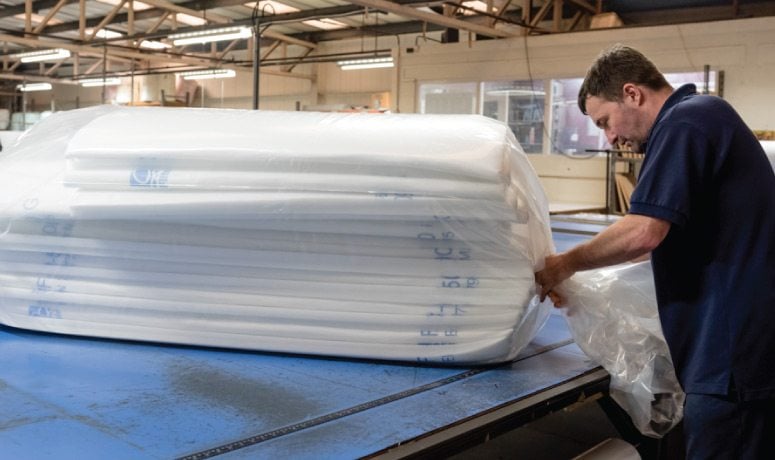 Man packing air filters for the Air Filtration department