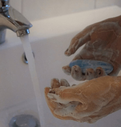 Person cleaning their hands - Returning to Work and Legionella Testing Blog