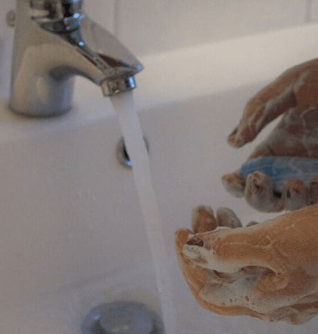 Person cleaning their hands - Returning to Work and Legionella Testing Blog