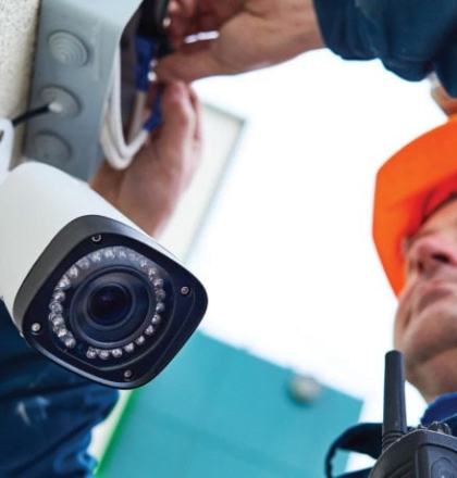 Man installing a CCTV camera - Protect Your Business with a Security System Beta Group