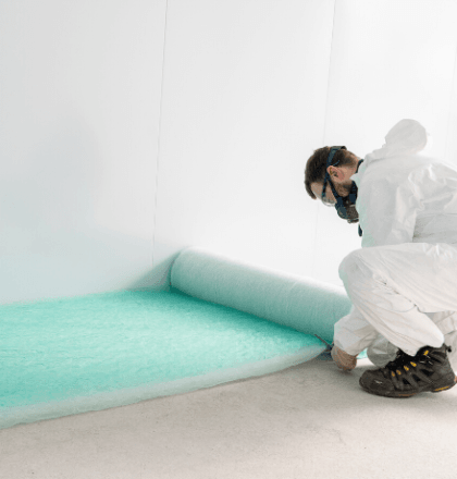 Man cutting a spray booth filter - Different Types of Air Filters