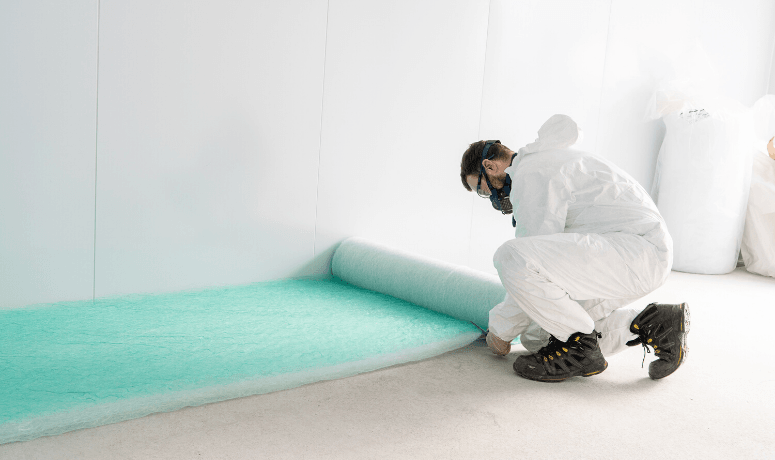 Man cutting a spray booth filter - Different Types of Air Filters