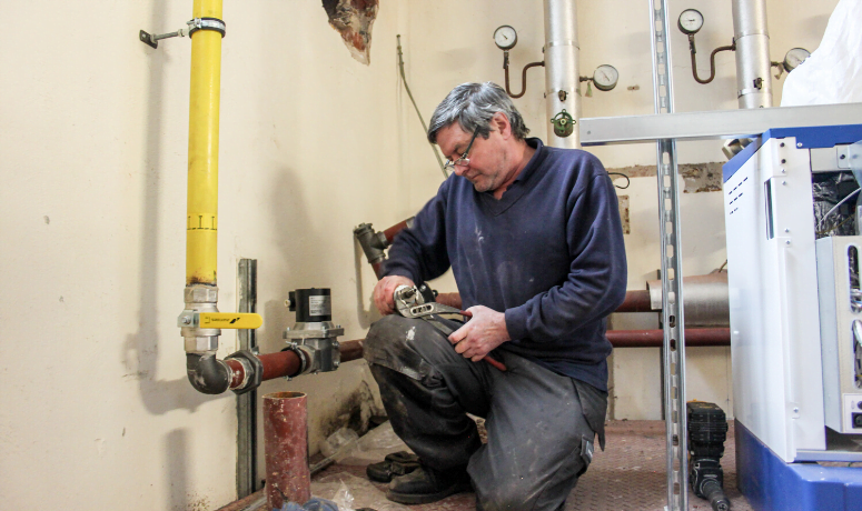 Man carrying out plumbing works - Now is the Time to Undertake Building Maintenance, Mechanical & Electrical Services