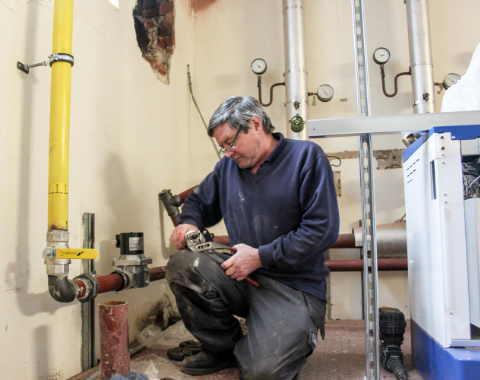 Man carrying out plumbing works - Facilities Maintenance Services Beta Group