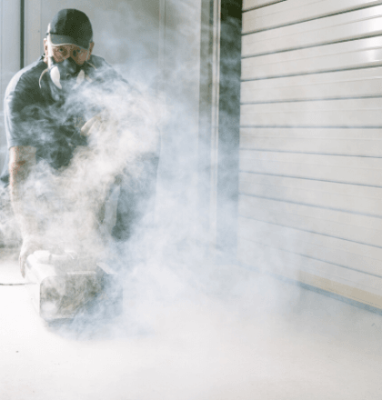 Man with smoke clearing machine to help Improve the Safety of a Spray Booth: Thorough Examination & Testing of LEV Systems Mobile Banner