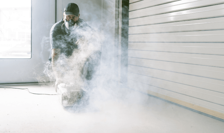 Man with smoke clearing machine to help Improve the Safety of a Spray Booth: Thorough Examination & Testing of LEV Systems Mobile Banner