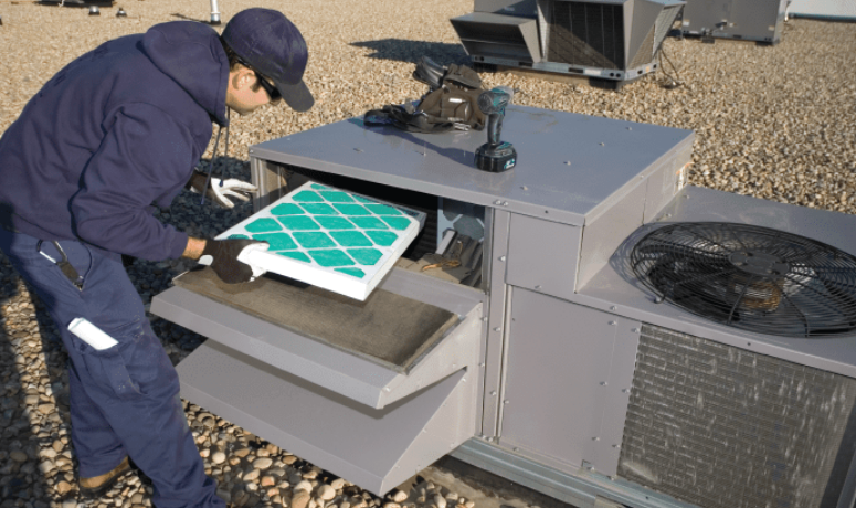 Engineer Installs HVAC Air Filter into Air Conditioning Systems
